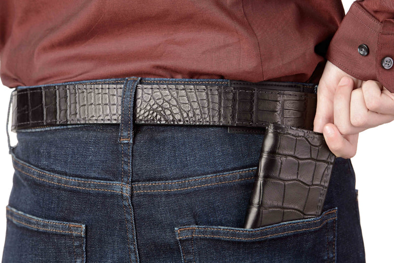 Man holding black alligator leather wallet and wear black leather belt by Bullhide Belts
